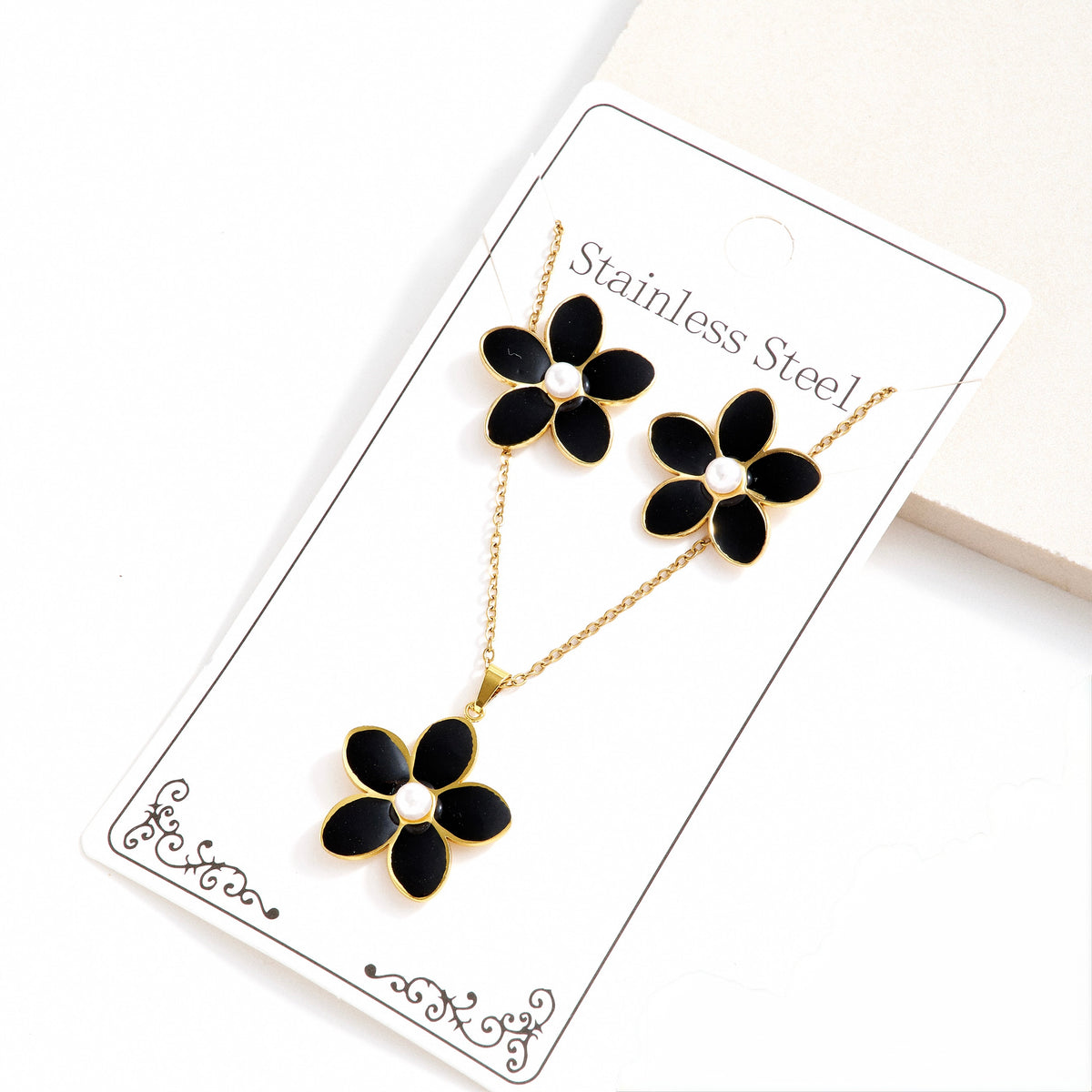 Set de collar + aretes flores negras - acero inoxidable
