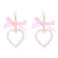 Aretes de corazones con perlitas y lazo rosa