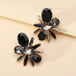 Aretes de pedrería gris y negra
