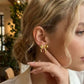 Aretes de lazos dorados - acero inoxidable