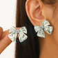 Aretes moños plateados- acero inoxidable