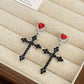 Aretes cruces negras con pedrería