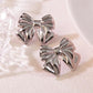 Aretes moños plateados- acero inoxidable