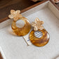 Aretes de flores doradas + carey acero inoxidable
