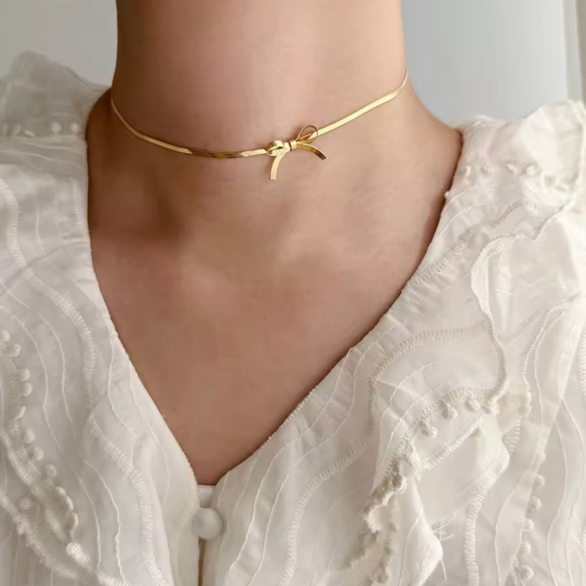 Collar con moño dorado - acero inoxidable