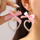 Aretes de corazones con perlitas y lazo rosa