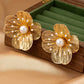 Aretes de flores doradas grandes
