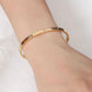 Brazalete dorado con piedritas - Acero inoxidable