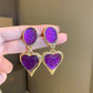 Aretes de corazones morados