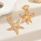 Aretes de estrellas doradas con pedrería