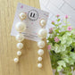 Aretes de perlas colgantes